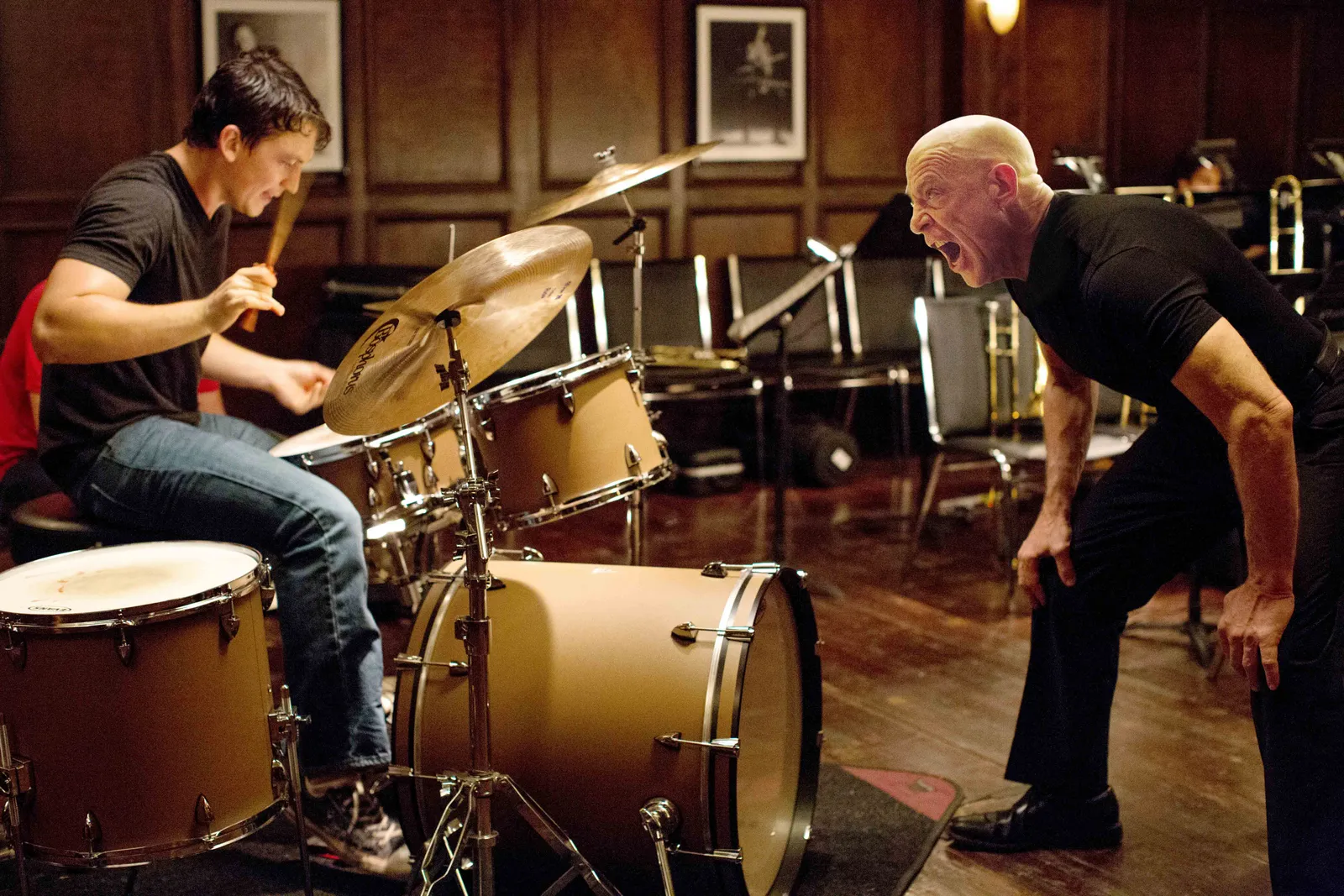 Fletcher (J.K. Simmons) yelling at Andrew (Miles Teller) to push him beyond his limits in the 2014 film, Whiplash.